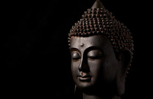 Meditating Buddha Statue Isolated On Black Background. Copy Space.