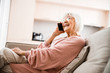 © Yakobchuk Olena - Cheerful old woman talking on cellphone at home