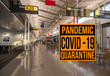 Pandemic sign warning of quarantine due to Covid-19 or corona virus in the USA against background of empty airport terminal