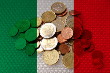 metal currency coins on the background of the national flag of Italy, the concept of financial development, devaluation, inflation, taxes