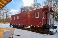 Old Fashioned Red Caboose Resting On A Train Track In The Snow In Northern USA