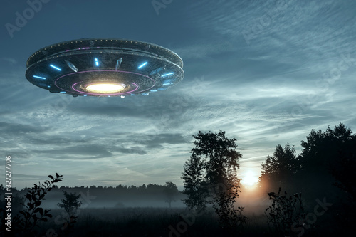 Cuadros en Lienzo UFO, an alien plate hovering over the field, hovering motionless in the air