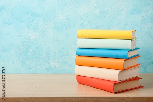 Fotografía Education concept with stack of books on wooden table