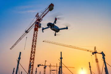 Drone over construction site. video surveillance or industrial inspection