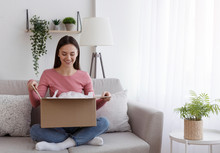 Satisfied Smiling Woman Looking Into Open Parcel Box