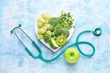 © Pixel-Shot - Plate with healthy products and stethoscope on color background