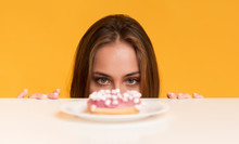 Hungry Woman Peeking Out Of Table Starving To Eat Donut