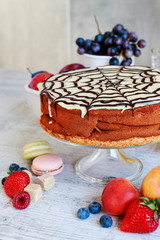 Canvas Print - Halloween chocolate spider web cake and various fruits around.