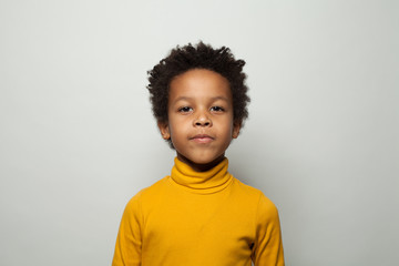 Portrait of cute black kid boy smiling on white background