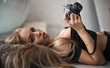 © Anton - Close up portrait of pretty girl with a retro camera. Beautiful sexy woman, long blond hair, tanned skin, holding digital photo camera, fashion trend, seductive