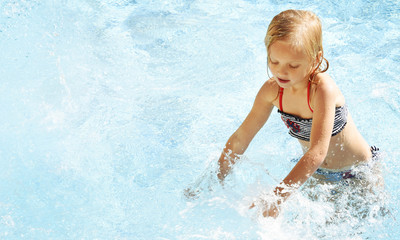 Little girl having fun time in the Swimming pool, Summer time, Vacation