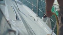 Man Washes A Yacht With A Hose With Water Slow Motion