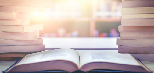 Wall Mural - Stack of books in the library and blur bookshelf background	