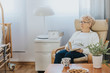 © Photographee.eu - Pensive elderly lady sitting with a book in an armchair in a nursing home
