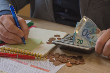 Man counting money at the table. business financial accounting