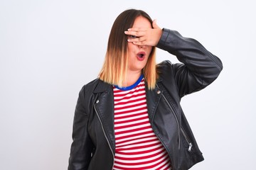 Poster - Young beautiful woman wearing striped shirt and jacket over isolated white background peeking in shock covering face and eyes with hand, looking through fingers with embarrassed expression.