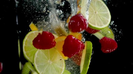 Wall Mural - berries, lemon, orange falling into water- slow motion