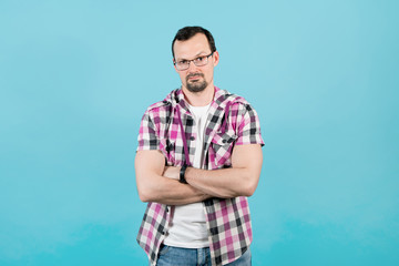 a young man in glasses looks inquiringly raising one eyebrow