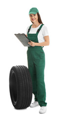 Wall Mural - Professional auto mechanic with tire and clipboard on white background