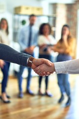 Canvas Print - Group of business workers standing together shaking hands at the office