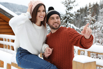 Poster - Happy couple in warm sweaters outdoors on winter day