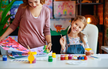 Wall Mural - mother and child daughter painting draws in creativity in kindergarten.