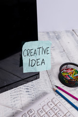 Poster - Writing note showing Creative Idea. Business concept for the overarching concept that captures audience interest Note paper taped to black computer screen near keyboard and stationary
