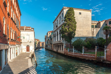 Wall Mural - View of narrow Canal with boats and gondolas in Venice, Italy