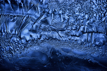 blue ice glass background, abstract texture of the surface of the ice on the glass, frozen seasonal water