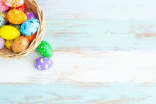 Groups Of Colorful Easter Eggs In The Basket On The Blue Wooden Table Preparing For Cerebrating The Event
