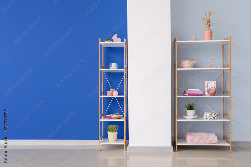 Modern shelf units near color wall