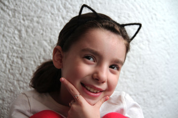 Wall Mural -  beautiful smiling girl posing against a white wall.