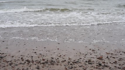 Wall Mural - Baltic sea waves washing on the shore. Baltic sea coast, small waves on the sea