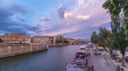 Wall Mural - View to the Pont De La Tournelle on the River Seine day to night timelapse with embankment.