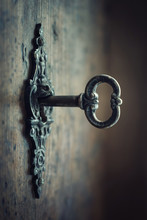 Old Key In Keyhole, Macro Shot. Gothic Style. Key To Knowledge. Concept And Idea For History, Education, Business, Security, Secret Background.