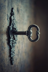 Fototapete - Old key in keyhole, macro shot. Gothic style. Key to knowledge. Concept and Idea for History, education, business, security, secret background.