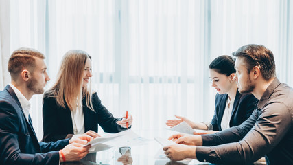 Wall Mural - Professional team communication. Business partners discussing cooperation conditions at modern conference room.