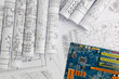 paper electrical engineering drawings and computer motherboard