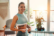 © Valerii Apetroaiei - Weight loss, slim body, healthy lifestyle concept. Slim young woman measuring her thin waist with a tape measure at home in the living room.