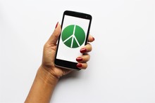 Woman Hand Red Nail Polish Holding Smartphone With Symbol Of Peace Sigh On Screen. Photo Isolate On White 