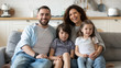 © fizkes - Portrait of happy family with little kids on couch
