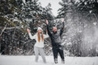 © Andrii - Couple playing with snow in the forest