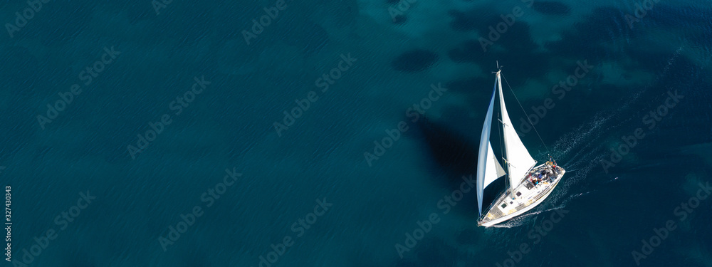 Aerial drone ultra wide photo of beautiful sail boat sailing in tropical exotic bay with emerald clear sea - obrazy, fototapety, plakaty 