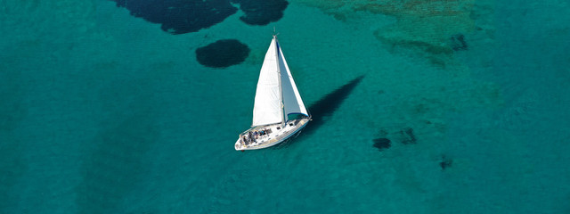 Wall Mural - Aerial drone ultra wide photo of beautiful sail boat sailing in tropical exotic bay with emerald clear sea