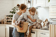 © JenkoAtaman - Happy family mother housewife and child   in laundry with washing machine .