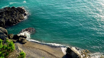 Wall Mural - 4K movie drone top view footage while turquoise sea waves breaking on sandy coastline. Aerial shot of beach meeting deep blue ocean water and foamy waves