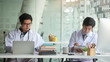 © wattana - Cropped shot view of Medical staff working at the hospital doctor and nurse checking a patient's medical record on a clipboard, healthcare and medical Close-up medical worker typing on laptop