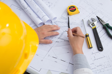 Yellow hard hat tools and drawings