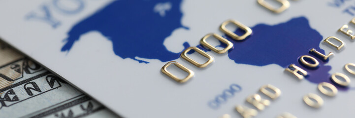 close-up of credit bank card and currency banknotes on table. cash and cashless, e-payments process 