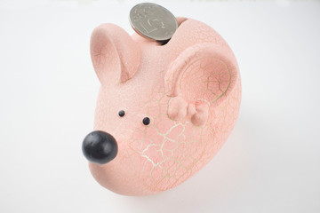 piggy Bank in the form of a light mouse and a coin on a white background, the concept of family Finance and budget